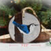 A 3.5 inch diameter wood slice with a hand-painted blue and white bird at Cove Creek Photography.